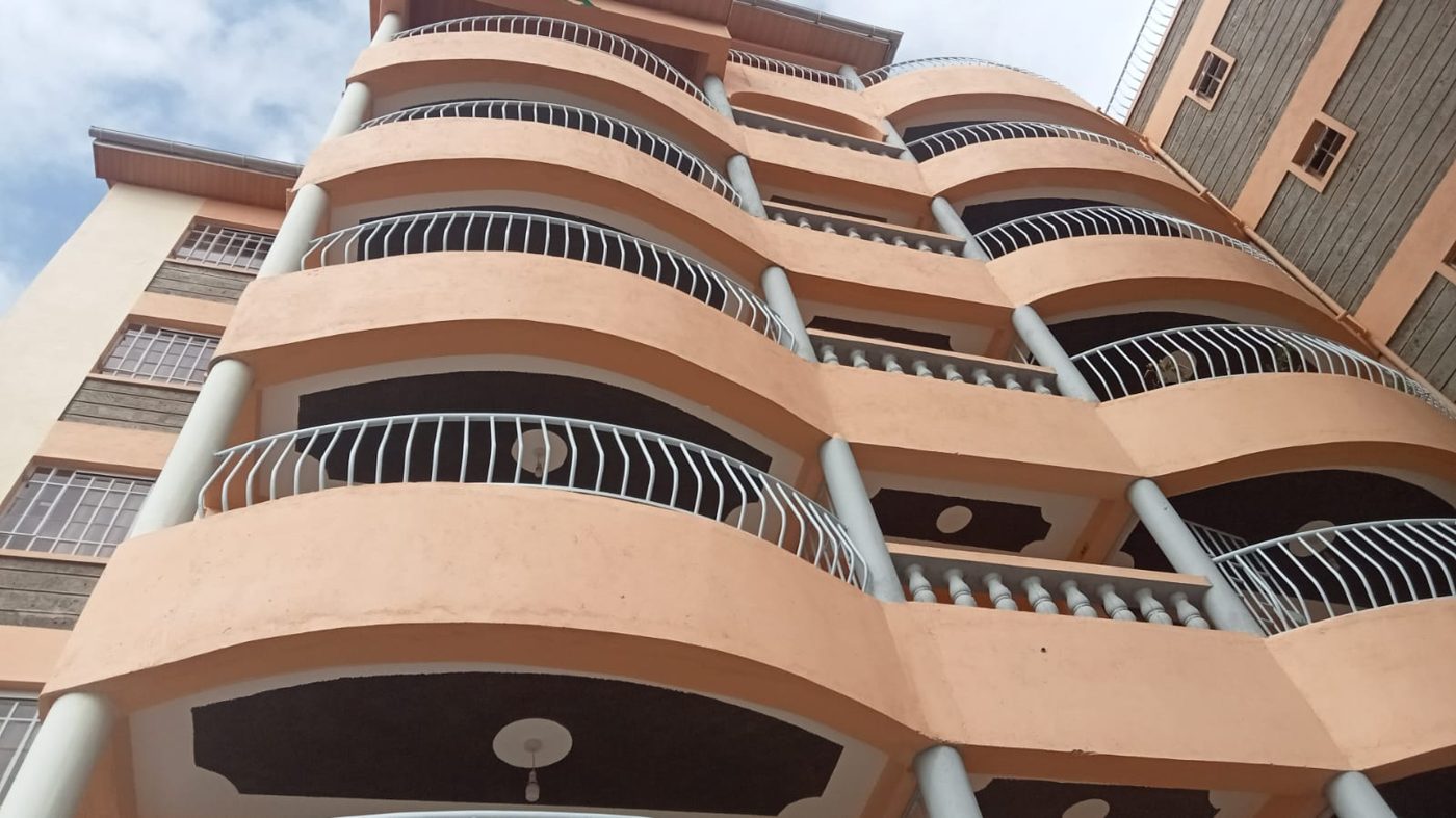 Bold coral-toned apartment balconies painted by Lush Coat