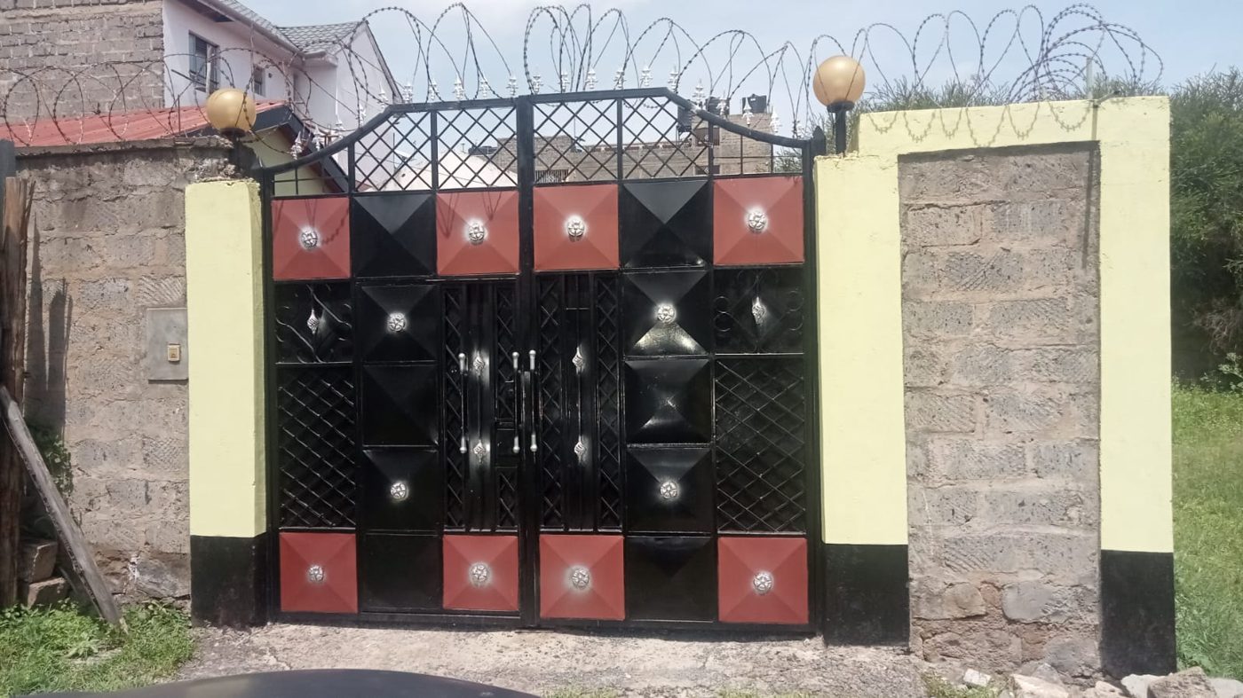 Yellow estate gate and perimeter wall